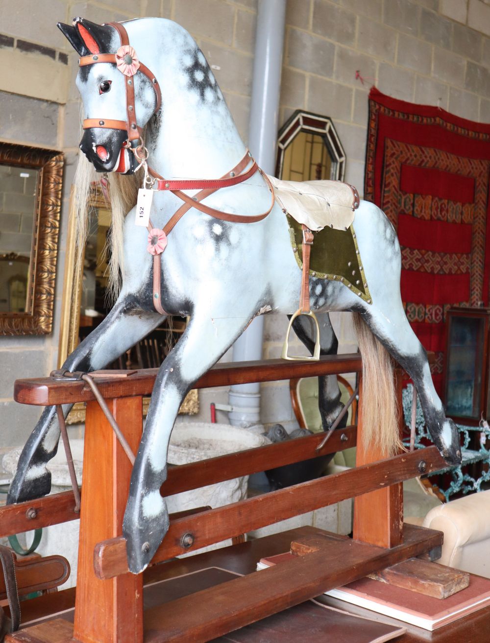 A mid 20th century Collinson dapple grey rocking horse on pine safety frame (restored by Stevenson during the 1980s) W.145cm, H.130cm